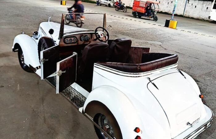 White vintage car with floral ribbons, Lucknow wedding.
