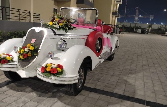 Decorated white vintage car, Lucknow wedding venue.